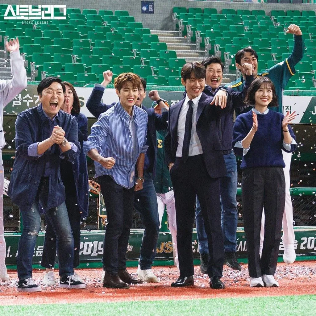 Team members are celebrating while the couch is calling someone from the filled with an hand gesture to come closer. A still from Korean Dramas About Sports.