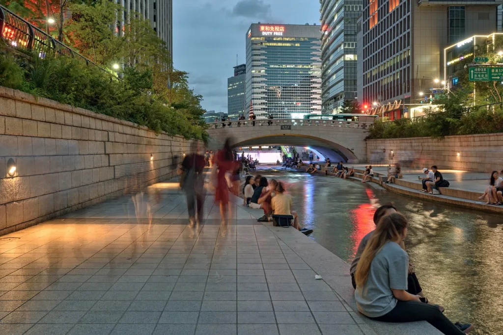 People walking by the river in a Slice-of-Life K-Drama hypothetical instance.