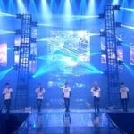 the BTS K-POP group on the stage performing.